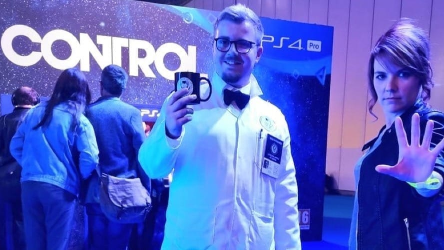 An image of a cosplayer of Dr Casper Darling and Jesse Faden from the video game CONTROL at the PlayStation area of a convention.